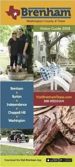a couple standing in a barrel in front of a tree