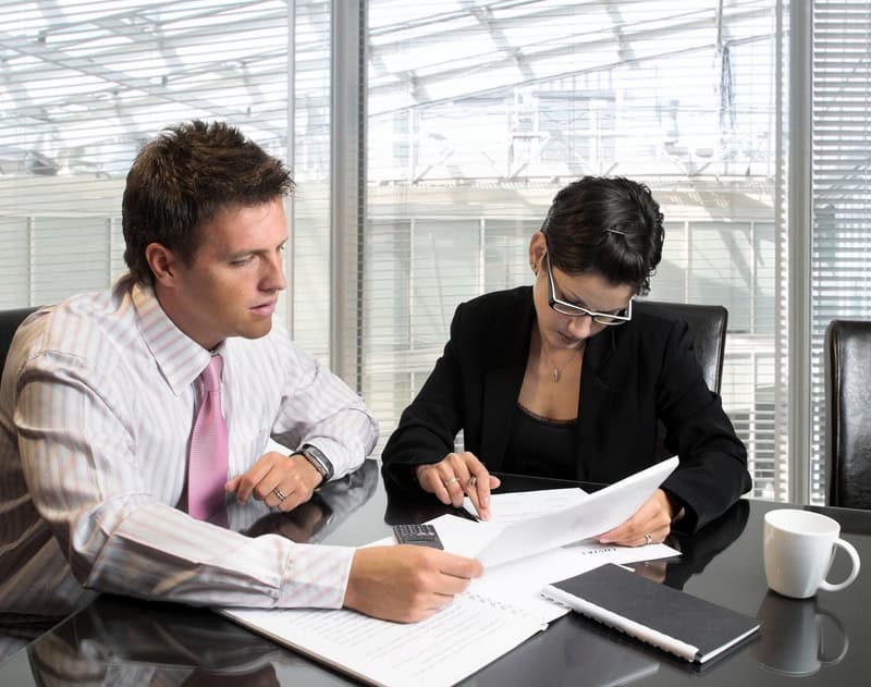 Business Consultation. Young and good-looking business people are working in the meeting room.