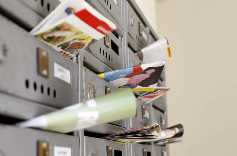 Mail marketing. Flyers and advertising brochures in mailboxes of a residential building