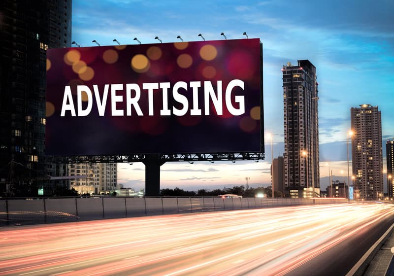 Billboard outdoor advertising on the highway during the twilight with text advertising on bokeh background
