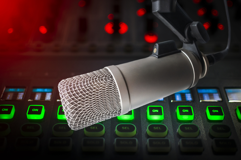 Radio advertising effectiveness concept with studio microphone and audio console